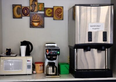 Coffee station with microwave, coffee maker, and water dispenser at Charter Senior Living of Paris in Paris, TN