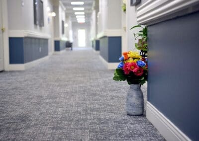 Brightly colored flower arrangement decorating a welcoming hallway at Charter Senior Living.