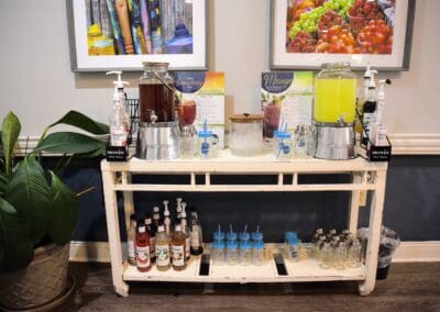 Hydration station at Charter Senior Living of Paris, TN, featuring infused water, tea, flavor syrups, and fresh cups for residents.